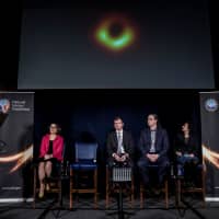 Astrophysicist Shepherd Doeleman shows the first image of a black hole Wednesday. | REUTERS