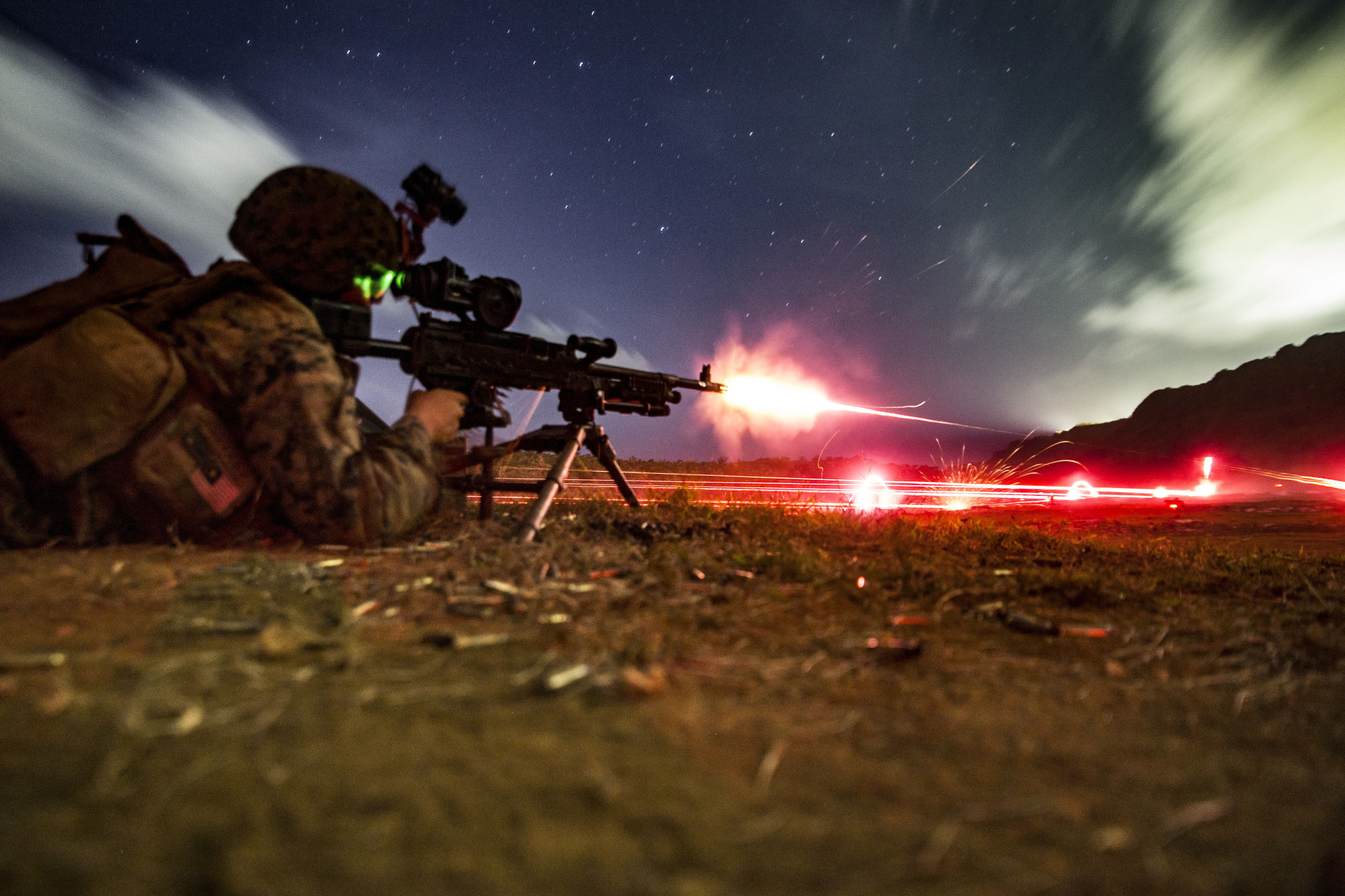 A rifleman with the U.S. 31st Marine Expedition Unit takes part in a live-fire exercise on Guam on March 11. Last month the 31st MEU practiced 'island hopping,' a tactic used by the U.S. in World War II against Japan that is now seen as key to any future war with China. | 31ST MARINE EXPEDITIONARY UNIT