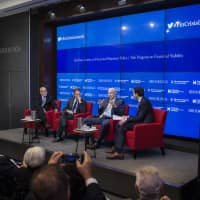 Former Fed Chairman Ben Bernanke and former U.S. Treasury Secretary Tim Geithner listen as former U.S. Treasury Secretary Hank Paulson speaks at a Brookings Institution event about the U.S. government\'s response to the 2007-2009 financial crisis on Sept. 12, 2018 . | BLOOMBERG