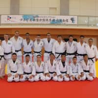 Brazilian judoka pose at a 2018 event in Hamamatsu, Shizuoka Prefecture. The country\'s men\'s head coach, Yuko Fujii (far left), will participate in her third Olympic Games next year in Tokyo. | COURTESY OF THE BRAZIL JUDO CONFEDERATION