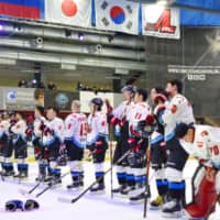 Nippon Paper Cranes players line up after their Game 3 defeat to Russia\'s PSK Sakhalin in the Asia League Ice Hockey playoff finals on March 14 in Yuzhno-Sakhalinsk, Russia. | KYODO