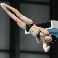 Twelve-year-old Rikuto Tamai competes during the national indoor diving championships at Tokyo Tatsumi International Swimming Center. The junior high school student became Japan\'s youngest national champion. | KYODO