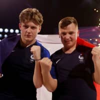Corentin \"MAESTRO\" Thullier (right) and Lucas \"DaXe\" Cuillerier of France pose as they celebrate winning the FIFA eNations Cup on Sunday in Maidstone, England. | REUTERS