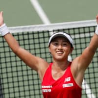 Misaki Doi celebrates after her Fed Cup World Group II playoff win over Bibiane Schoofs of the Netherlands on Sunday in Osaka. | REUTERS