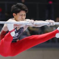 Kakeru Tanigawa competes in the horizontal bar portion of the all-around finals of the national gymnastics championships on Sunday at Takasaki Arena. | KYODO