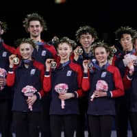 Team USA members pose with their gold medals during the awards ceremony at the World Team Trophy on Saturday night in Fukuoka. The United States won its fourth title in the biennial competition. | AP