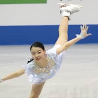 Rika Kihira performs her women\'s short program routine at the World Team Trophy on Thursday in Fukuoka. Kihira leads with 83.97 points. | AP