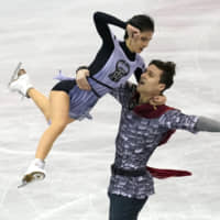 Russia\'s Natalia Zabiiako and Alexander Enbert compete in the pairs short program on Friday. They placed first in the short program with 75.80 points. | AP