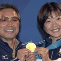 Running coach Yoshio Koide (left) poses with Naoko Takahashi after she won the marathon at the 2000 Sydney Olympics. Koide died on Wednesday, aged 80. | KYODO
