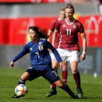 Japan\'s Emi Nakajima controls the ball in front of Germany\'s Alexandra Popp during their match on Tuesday in Paderborn, Germany. | REUTERS
