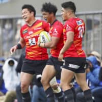 Takuya Yamasawa (center) and Wolf Pack teammates celebrate a try in Saturday\'s warm-up match against the Western Force at Prince Chichibu Memorial Rugby Ground. The Wolf Pack won 51-38. | KYODO