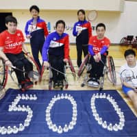 Para-badminton players pose with shuttlecocks placed to read “500” on Friday night in Tokyo’s Edogawa Ward. Saturday marked 500 days until the opening of the 2020 Paralympics. | KYODO