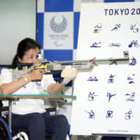 Three-time Paralympic shooter Aki Taguchi participates in the unveiling of the pictograms for the 2020 Paralympics on Saturday. | KYODO