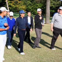 In his previous visit to Japan last November, U.S. President Donald Trump (right) played golf at planned Olympic venue Kasumigaseki Country Club with Prime Minster Shinzo Abe (center) and professional golfer Hideki Matsuyama (left). | KYODO