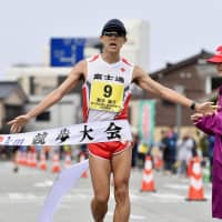 Yusuke Suzuki crosses the finish line at the race walk national championships on Sunday in Wajima, Ishikawa Prefecture. The 20-km world record holder set a new national record of 3 hours, 39 minutes and 7 seconds in the 50-km race. | KYODO