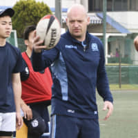 Scotland head coach Gregor Townsend instructs players at a high school rugby clinic in Yokohama on Monday. | KYODO