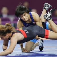 Kaori Icho (top) competes in a women\'s 57-kg weight class match at the Asian Championships on Friday in Xian, China. | KYODO