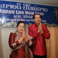 Laotian Ambassador Viroth Sundara (right) and his wife, Simuang, celebrate the Laotian new year, or Buddhist year 2562, at the Laotian Embassy in Tokyo on April 14. | YOSHIAKI MIURA
