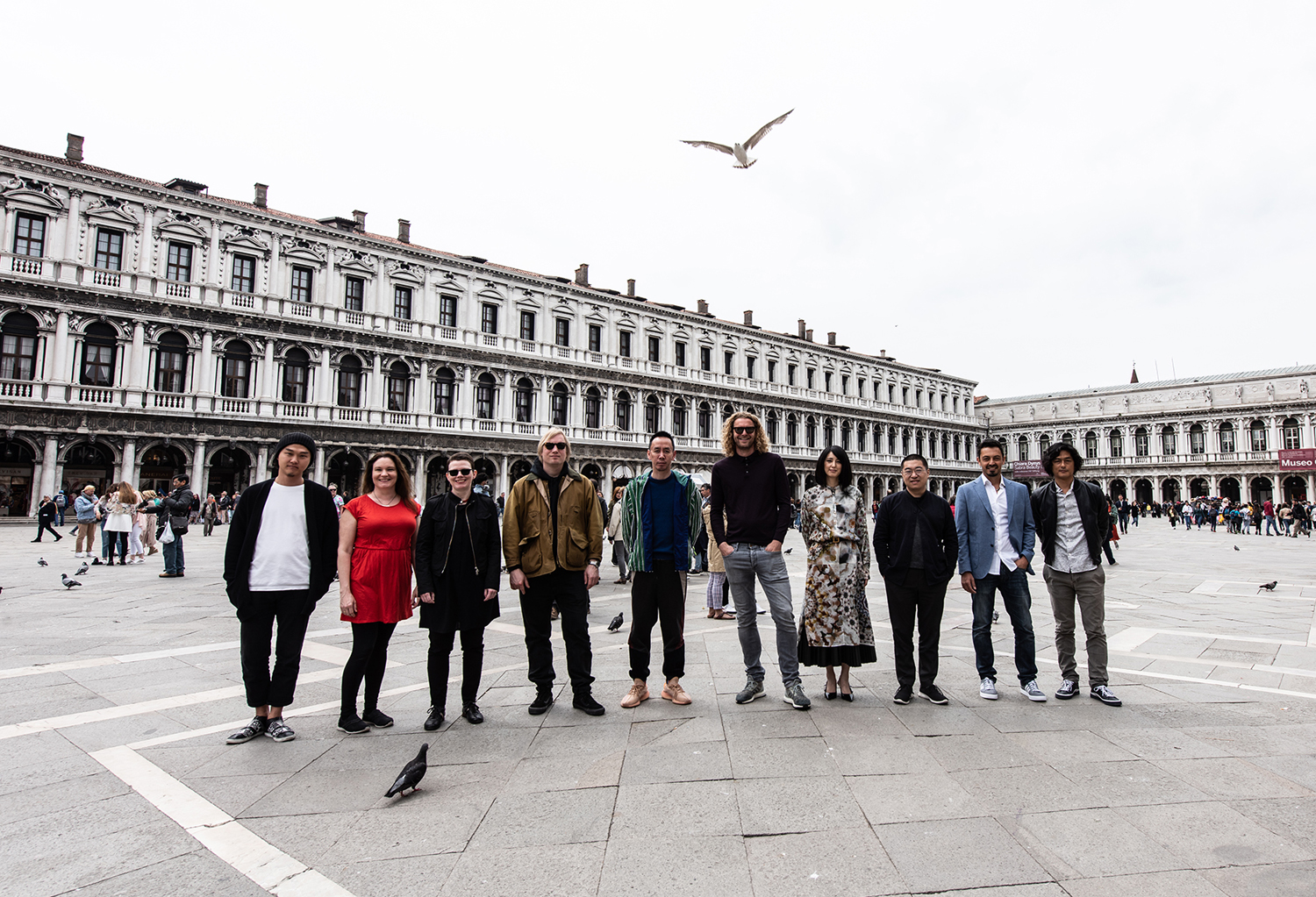 International artists (from left, Ahhi Choi, musician Tinna Thorsteinsdottir, Aesa Bjork, Chris Succo, Huang Yuxing, Florentijn Hofman, Miwa Komatsu, Yang Yongliang, Fabio Modica and Ryotaro Muramatsu) at Venice’s Piazza San Marco on May 8, commemorating the opening of the group exhibition “Diversity for Peace!” The exhibit was organized by the Karuizawa New Art Museum Venice branch and runs through Nov. 24. | TATSUYA AZUMA