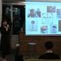 Tango Inc. Director Kayo Tango speaks about the company\'s towel brand, Olsia, at the ninth Satoyama Cafe on April 11 in Tokyo. | YOSHIAKI MIURA