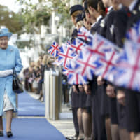 Queen Elizabeth II walks during a visit to the headquarters of British Airways at Heathrow Airport, London, to mark their centenary year Wednesday. | TOLGA AKMEN / PA / VIA AP