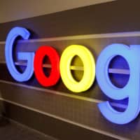 An illuminated Google logo is seen inside an office building in Zurich last December. | REUTERS