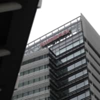 The Nissan Motor Co. logo is seen atop the company\'s global headquarters in Yokohama. | BLOOMBERG