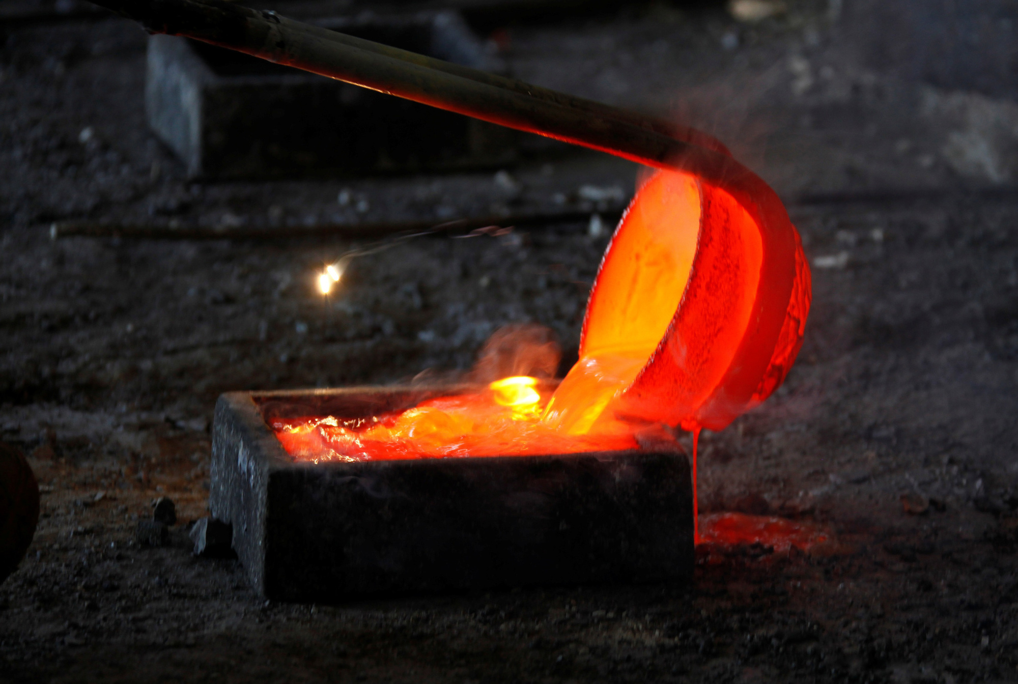 Molten lanthanum, a rare earth metal, is poured into a mold at Jinyuan Co.'s smelting workshop, near the town of Damao in the Inner Mongolia Autonomous Region of China, in 2010. | REUTERS