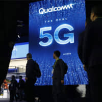 A sign advertises 5G at the Qualcomm booth at CES International in Las Vegas in January. Qualcomm and Apple drove declines in technology stocks on Wednesday2. Qualcomm plunged following a federal judge\'s ruling against the chipmaker in an antitrust case. | AP