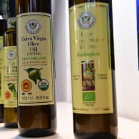 Bottles of Sicily produced organic olive oil are displayed on Wednesday at the TUTTOFOOD fair, the international B2B show dedicated to food and beverage and organized by Fiera Milano from 6th to 9th may 2019, in Milan, Italy. | AFP-JIJI