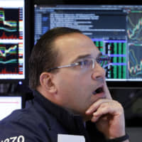 Specialist Anthony Matesic works on the floor of the New York Stock Exchange Tuesday. Stocks are opening broadly higher on Wall Street as the market claws back some of the ground it lost in a big slide a day earlier. | AP