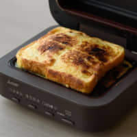 French toast is made with a Mitsubishi Electric Corp. Bread Oven during a demonstration in Tokyo last month. | BLOOMBERG