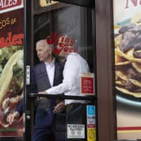 Former Vice President and Democratic presidential candidate Joe Biden (left) and Los Angeles Mayor Eric Garcetti leave a Mexican restaurant after talking to patrons, in Los Angeles May 8. | AP