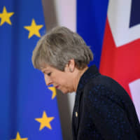 British Prime Minister Theresa May leaves after giving a news briefing in Brussels, Belgium, on March 22. | REUTERS