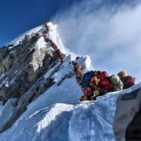 This photo taken on May 22 and released by @nimsdai Project Possible shows heavy traffic of mountain climbers lining up to stand at the summit of Mount Everest. | @NIMSDAI PROJECT POSSIBLE / VIA AFP-JIJI