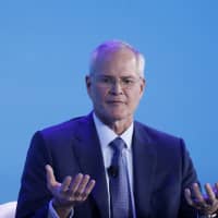 Exxon Mobil CEO Darren Woods says the answer to climate change will be found in U.S. government laboratories. | BLOOMBERG