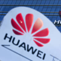 An information board for an employees\' shuttle bus is on display near the Huawei office building at its research and development center in Dongguan, in south China\'s Guangdong province, last December. | AP