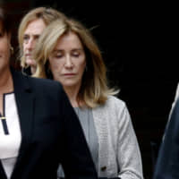 Actor Felicity Huffman leaves the federal courthouse after facing charges in a nationwide college admissions cheating scheme in Boston Monday. | REUTERS