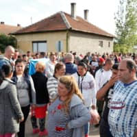Roma people gather on the outskirts of the town to commemorate the killings of Roma people by right-wing militants in 2009, in Torokszentmiklos, Hungary, Tuesday. | ZOLTAN BALOGH / MTI V/ IA AP