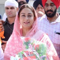 Minister of Food Processing Industries Harsimrat Kaur Badal holds flowers after paying her respects at the Golden Temple in Amritsar on Friday. | AFP-JIJI