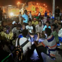 Sudanese protesters gather near the military headquarters in Khartoum on Sunday during an ongoing sit-in demanding a civilian-led government transition. | AFP-JIJI