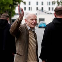 Pierre Lambert, the father of French quadriplegic Vincent Lambert, who has been in a deep vegetative state for more than a decade, arrives with two monks at the Sebastopol Hospital in Reims, France, Monday. | REUTERS