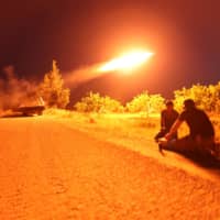 Fighters from Hayat Tahrir al-Sham (HTS), Syria\'s former al-Qaida affiliate, which controls most of Idlib province as well as parts of neighboring Aleppo, Hama and Latakia provinces, fire a missile at regime positions on May 13in the northern part of Syria\'s Hama province. Clashes on the edge of a jihadist bastion in northwestern Syria have killed at least 42 fighters in 24 hours, a monitor said after regime bombardment on the region devastated health services. | AFP-JIJI