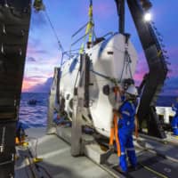 A technician checks the submarine DSV Limiting Factor aboard the research vessel DSSV Pressure Drop above the Pacific Ocean\'s Mariana Trench in an undated photo released by the Discovery Channel Monday. | ATLANTIC PRODUCTIONS FOR DISCOVERY CHANNEL / TAMARA STUBBS / HANDOUT / VIA REUTERS