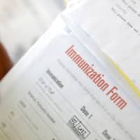 A camper\'s immunization form and physician\'s stamp is seen at the Rosmarins Day Camp and Cottages office in Monroe, New York, May 20. | REUTERS