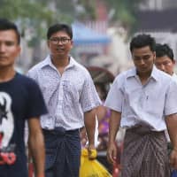 Reuters reporters Wa Lone (center, left) and Kyaw Soe Oo (center, right) walk free outside Insein Prison after receiving a presidential pardon in Yangon on Tuesday. | REUTERS