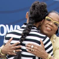 U.S. singer-songwriter Alicia Keys (left) and U.S. media executive, actress and talk show host Oprah Winfrey hug as they arrive to attend The Hollywood Reporter\'s Empowerment In Entertainment Event 2019 at Milk Studios on Tuesday in Los Angeles. | AFP-JIJI