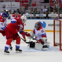 Russian President Vladimir Putin scores a goal during the hockey game at the Bolshoy Ice Dome in Sochi, Russia, on Friday. | AFP-JIJI