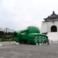 Giant balloons in the shape of a Chinese military tank and \"Tank Man,\" an artwork by artist Shake, are seen in front of Chiang Kai-Shek Memorial Hall in Taipei on Tuesday, ahead of 30th anniversary of the 1989 military crackdown on pro-democracy protesters in Beijing\'s Tiananmen Square . | AFP-JIJI