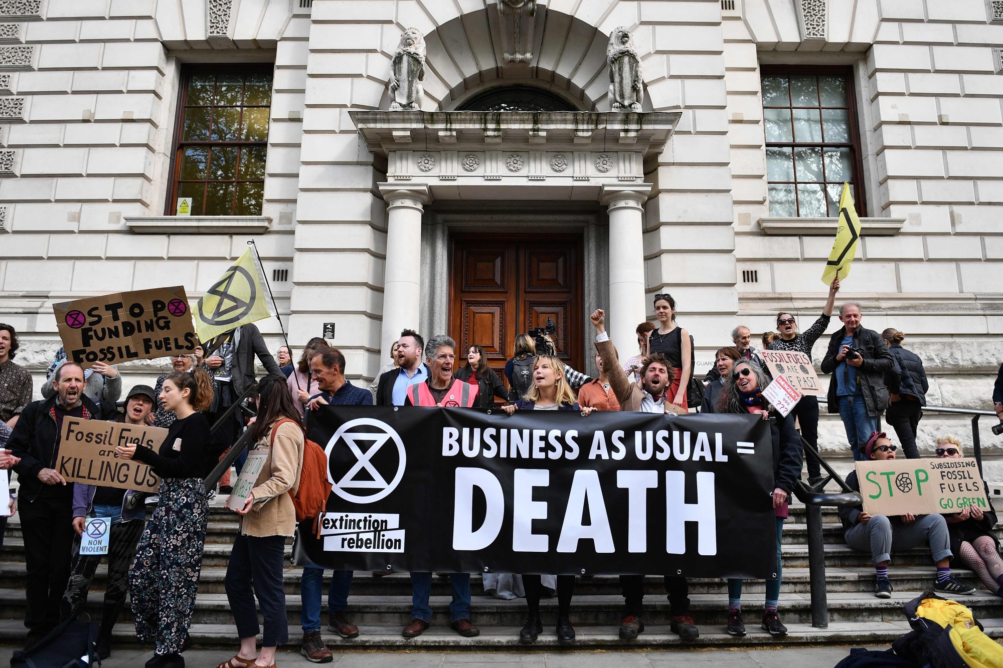 Climate change activists stage a protest outside the Treasury building in central London on April 25 during environmental protests by the Extinction Rebellion group. | AFP-JIJI